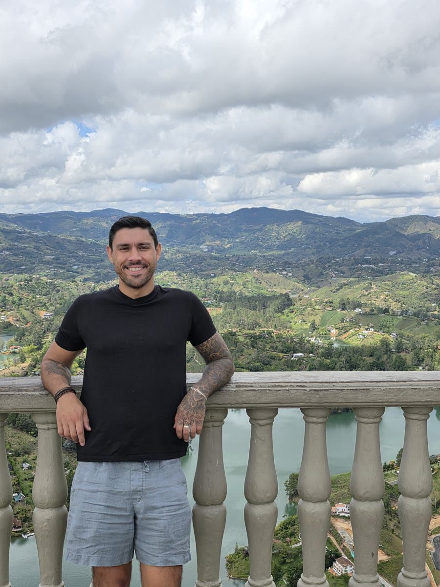 Devin smiling at a lookout above the lakes of Guatapé